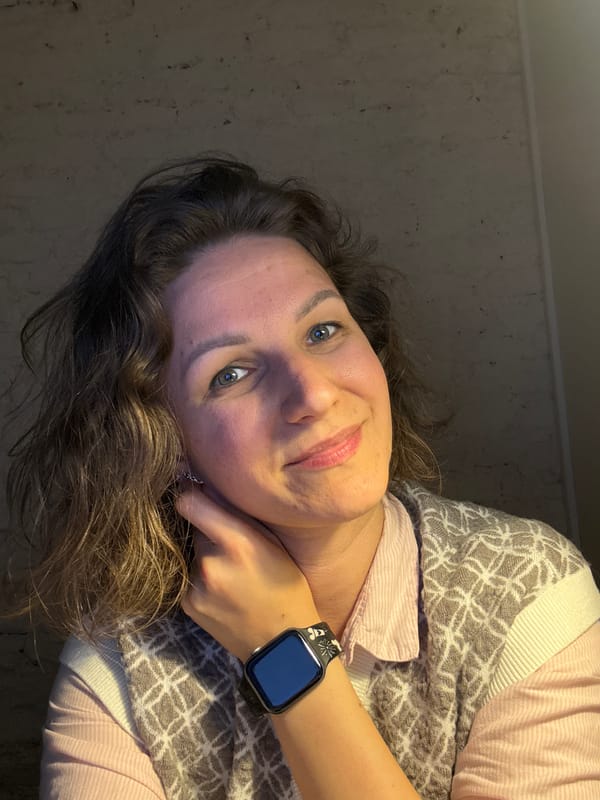 Woman photographed indoors in Saint Petersburg wearing pink shirt