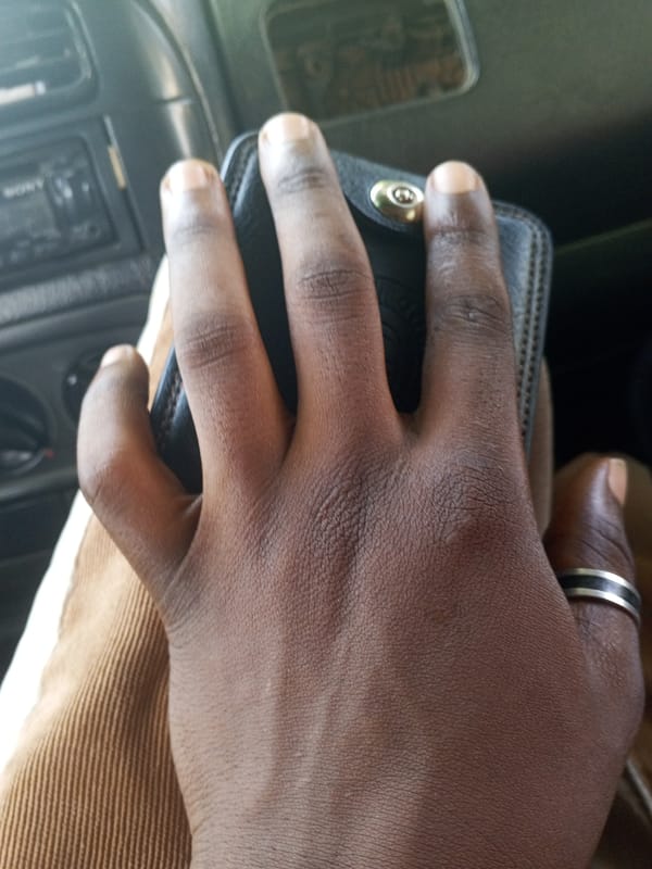 Wallet in hand, street view from a car in Abuja