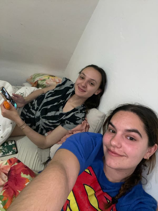 Two women take selfie in decorated indoor space