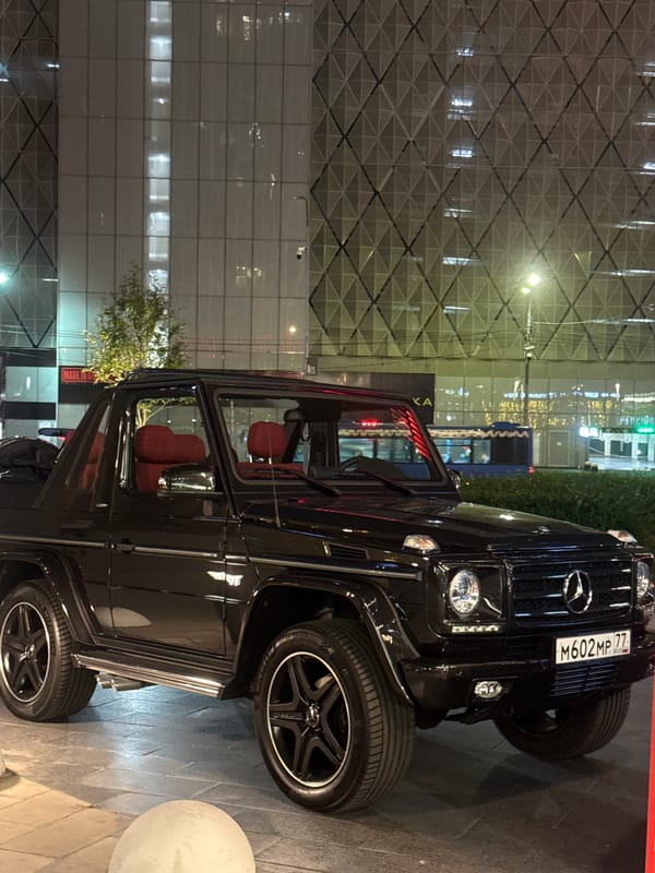 Supercar row outside a Moscow sushi spot, summer night