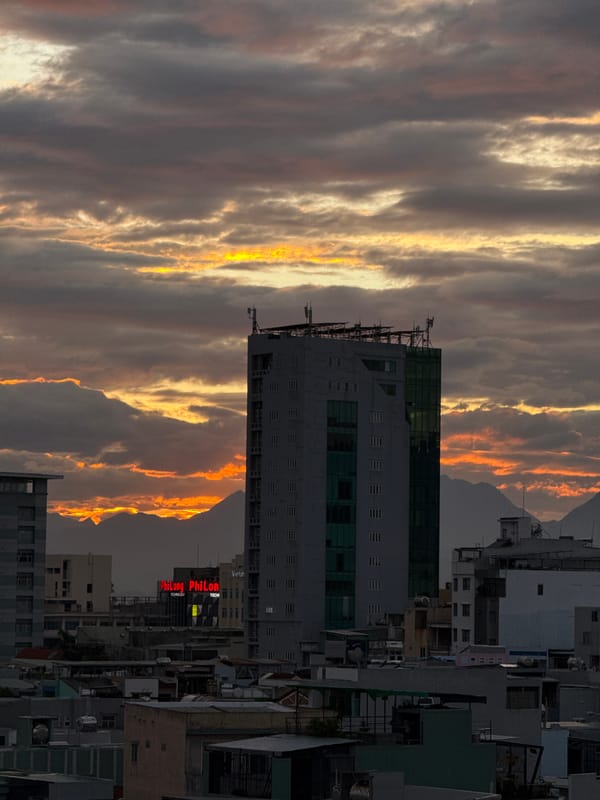 Da Nang skyline at golden hour, clouds layered above the city