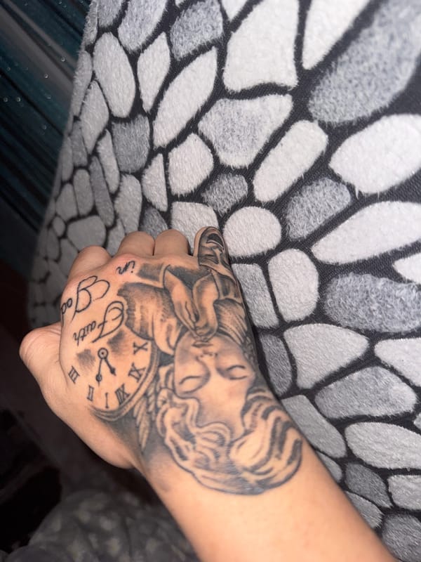 Person displays religious tattoos in intimate photo session