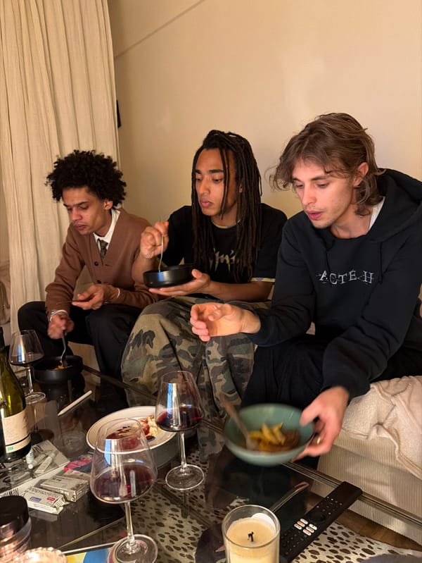 Young men share casual evening meal in Paris residence