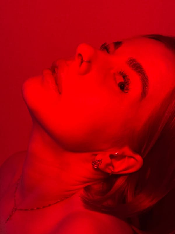 Woman photographed taking elevator selfies under red lighting in Russia