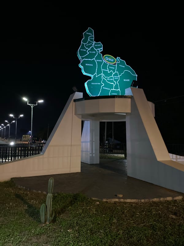 Night scenes around Bukuru's lit roundabout monument and surrounding streets