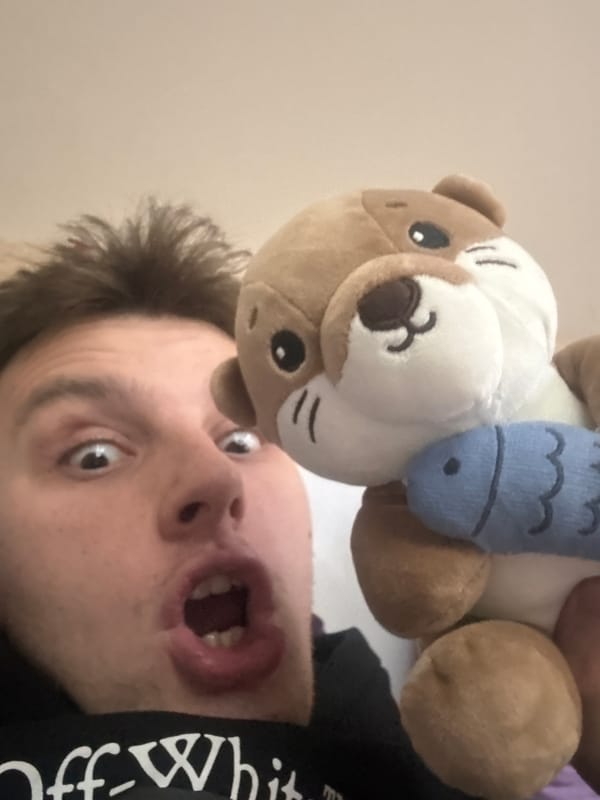 Playful selfie with plush otter toy in Plovdiv