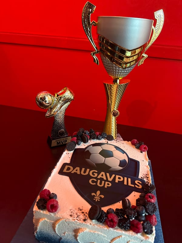 Soccer celebration cake and trophy displayed in Daugavpils