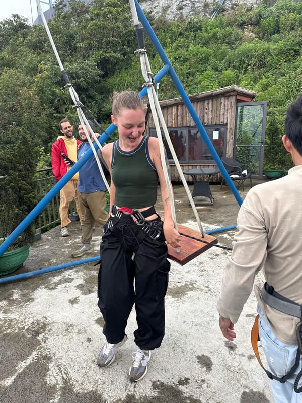 Woman swings safely on playground equipment in Binh Lu
