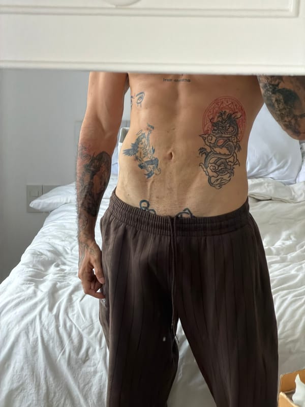 Tattooed man takes multiple mirror selfies in Bangkok bedroom