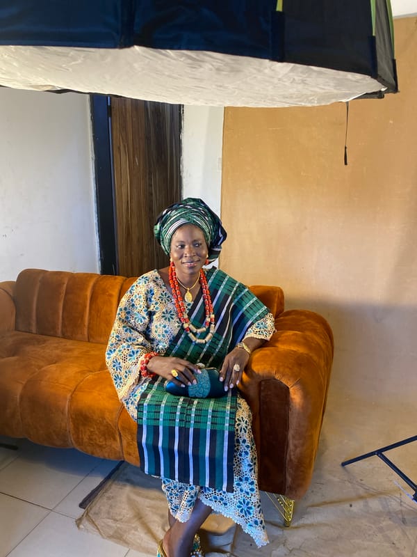 Woman poses for traditional portrait session in Bukuru studio