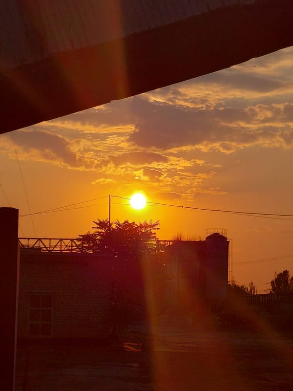 Sunset over a Ukrainian industrial yard, rails and all
