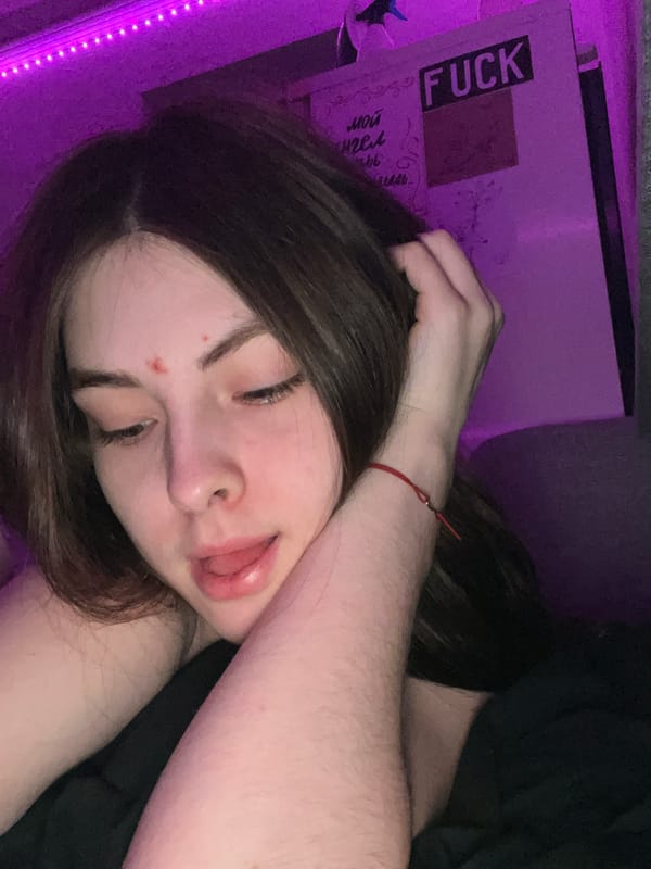 Private photo session captured in purple-lit Saint Petersburg apartment