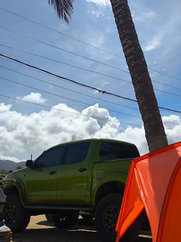 Pickup truck parked at beach campsite in El Espinal