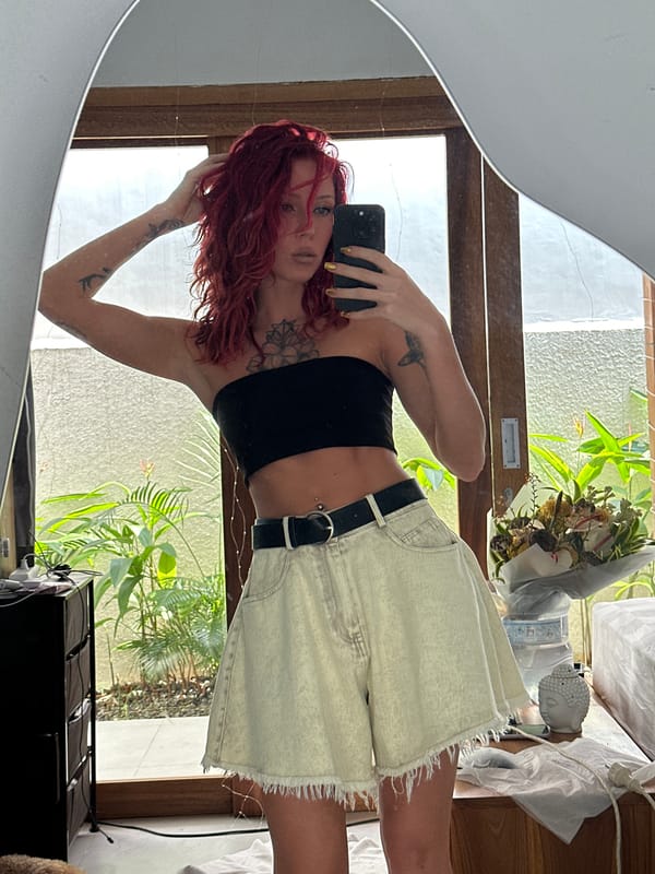 Red-haired woman takes selfies in North Kuta, Indonesia