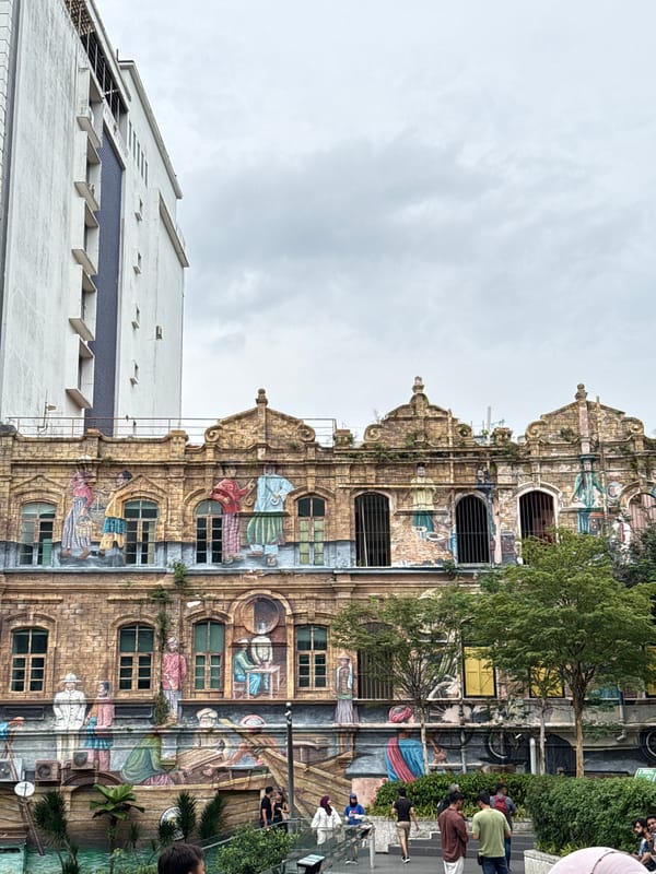 Tourist documents historic Kuala Lumpur landmarks during morning sightseeing walk