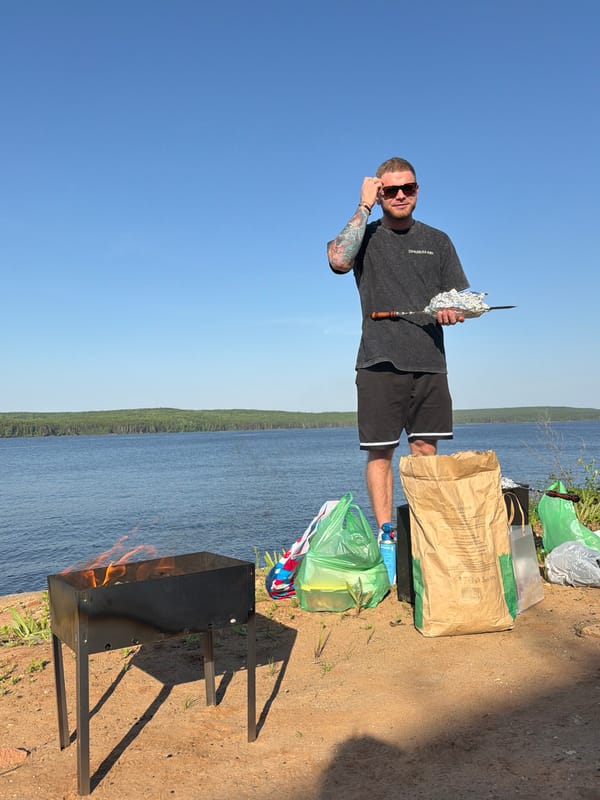 Man grills food by waterfront in Chaikovsky, Russia