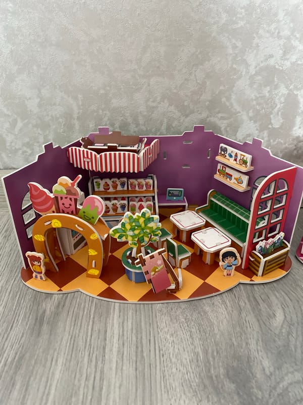 Handmade cardboard dioramas and decorative plants in a cozy space