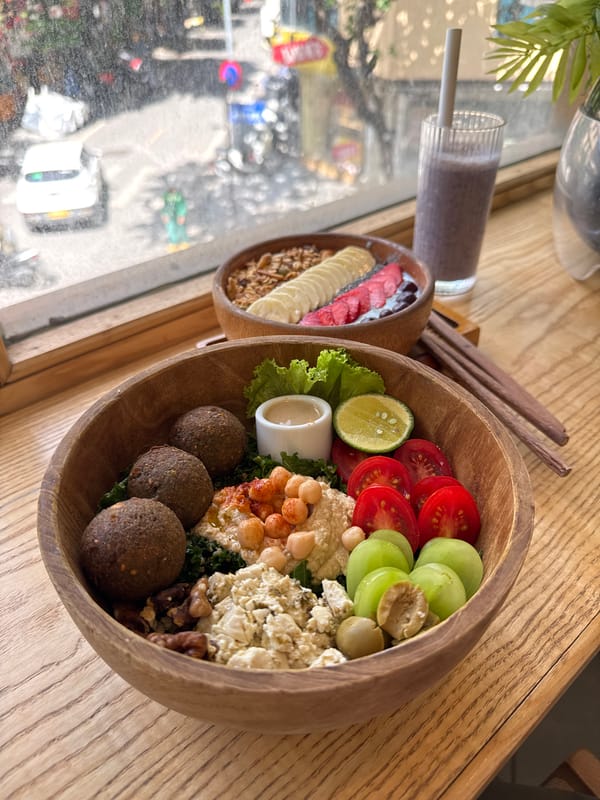 Colorful salad in wooden bowls by a Hà Nội window