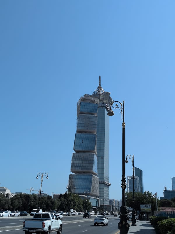 Baku's Flame Towers and street-side nature on a sunny morning