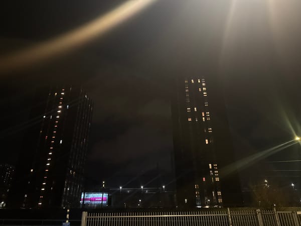 Welcome banner displayed on illuminated apartment buildings in The Hague