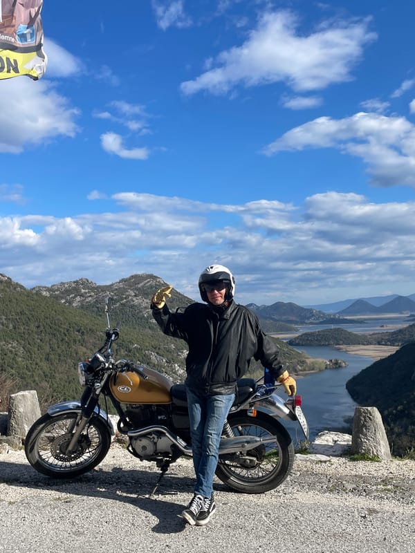 Motorcyclist pauses at Montenegro river overlook for scenic views