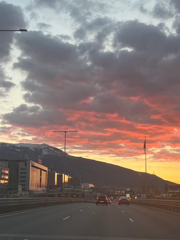 Dramatic cloudy skies over snow-capped mountains from Sofia highway