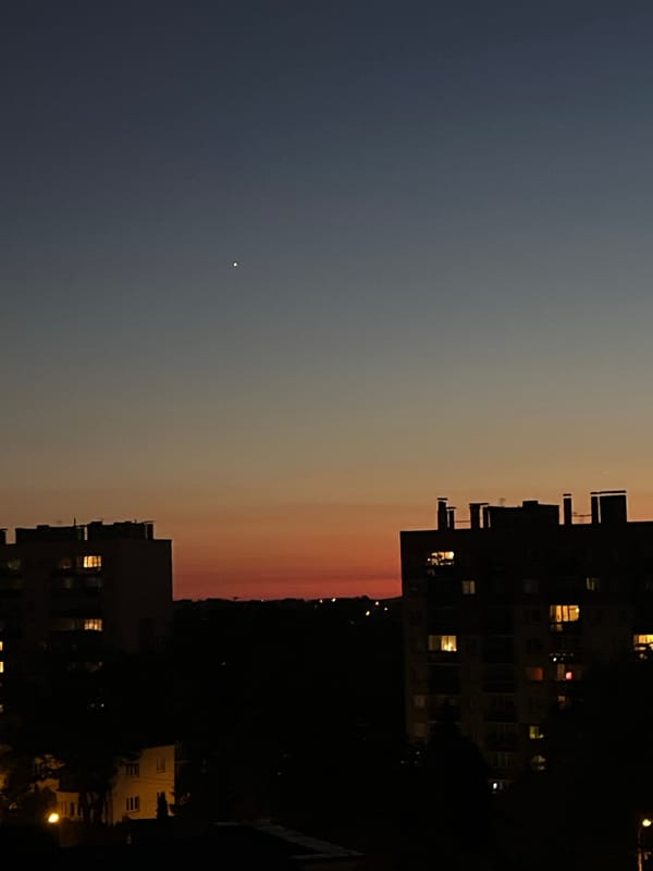 City skyline at dusk, blue-to-orange sky from multiple angles