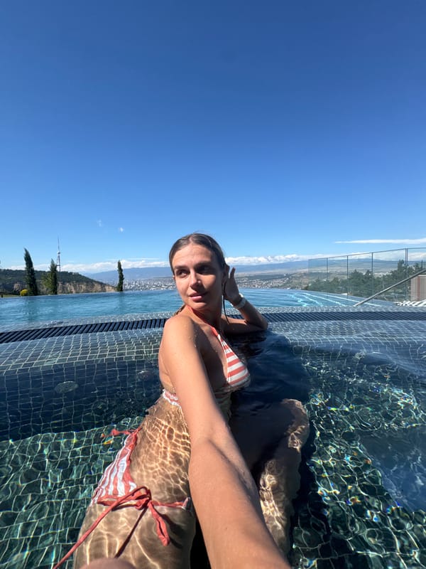 Rooftop infinity pool session overlooking Tbilisi on a summer morning