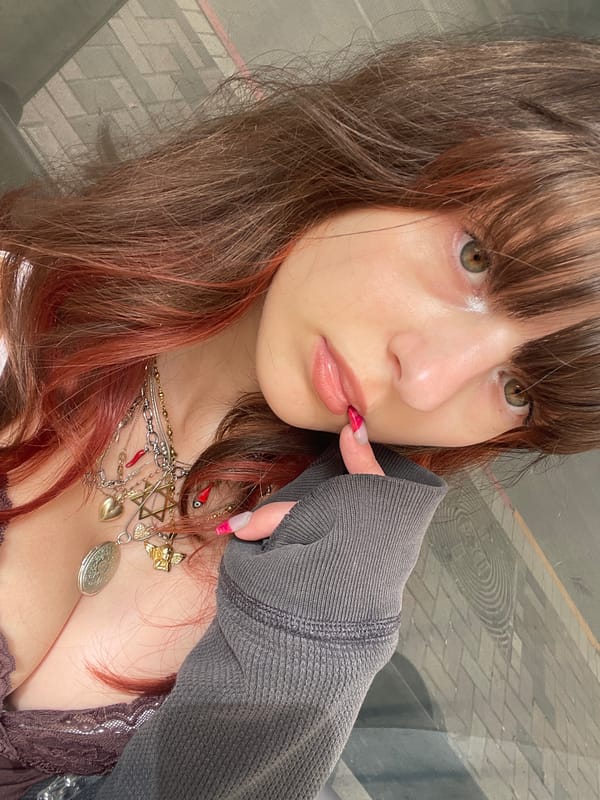 Woman takes morning selfies on rainy Petah Tikva streets