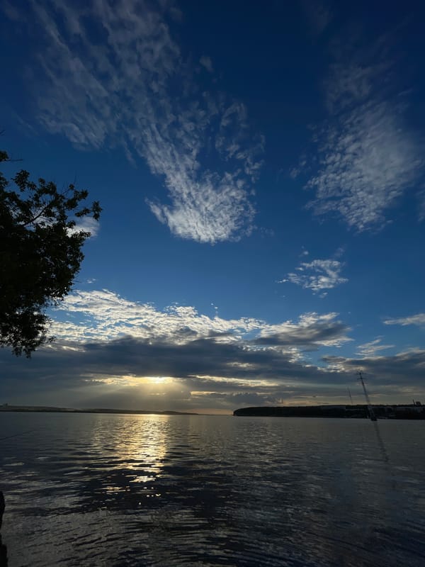 Golden hour light and dramatic skies over an urban waterfront
