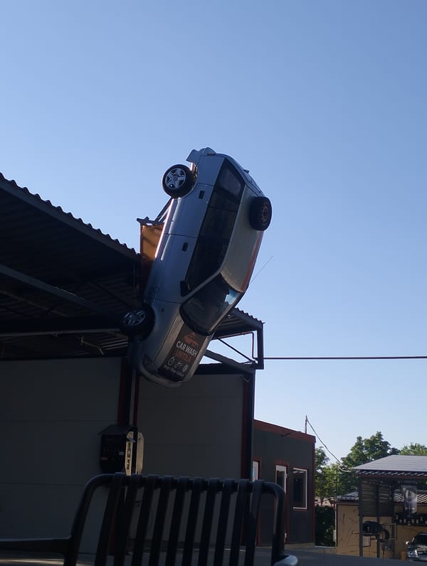 Upside-down car on a rooftop in rural Moldova