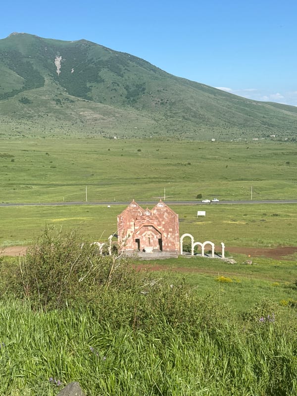 Visitors document religious memorial site with crosses and church