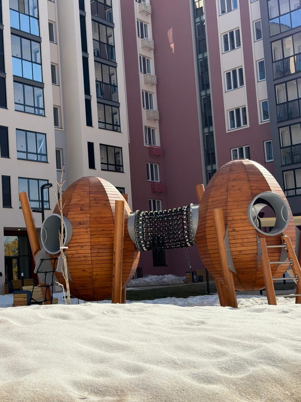 Wooden playground and residential buildings documented in Pervomaysky Russia