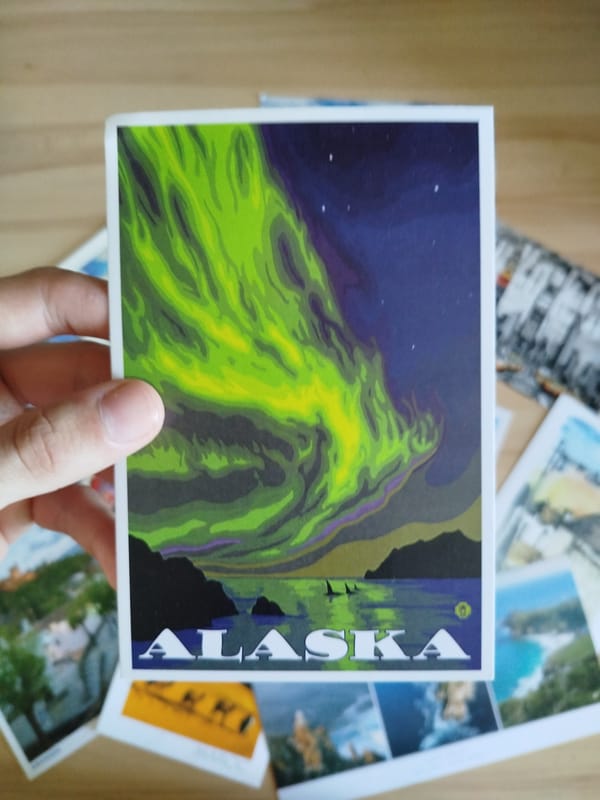 Travel postcards and magnets sorted across a Varna tabletop