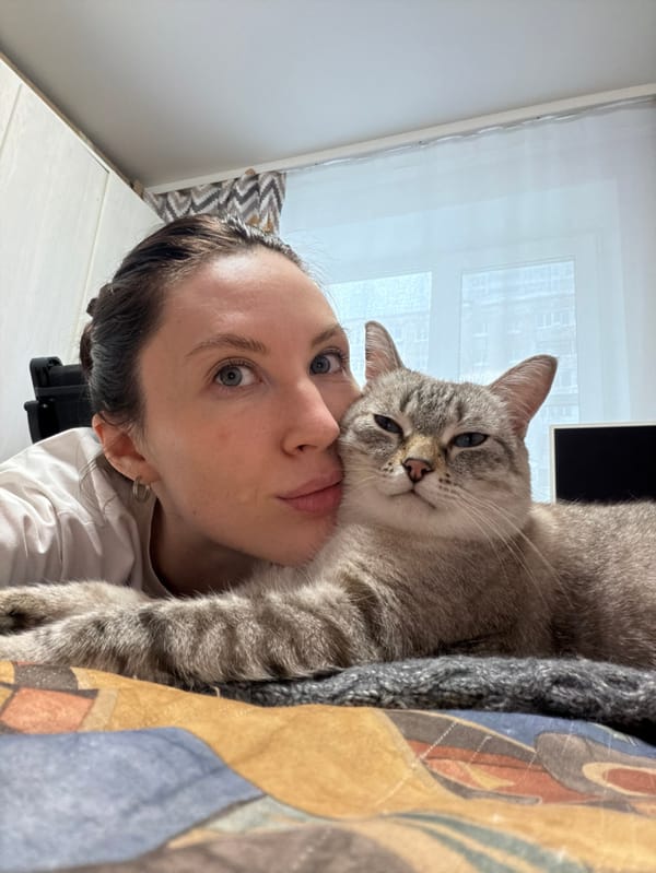 Woman and cat share quiet morning moments in Perm home
