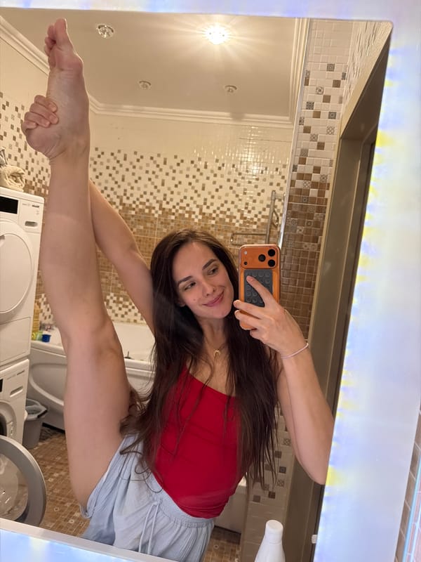 Vertical leg split practice in a Ufa bathroom