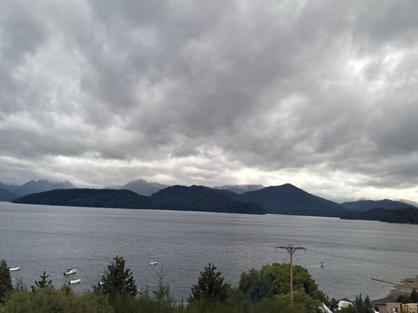 Overcast skies blanket lake landscape in Villa La Angostura