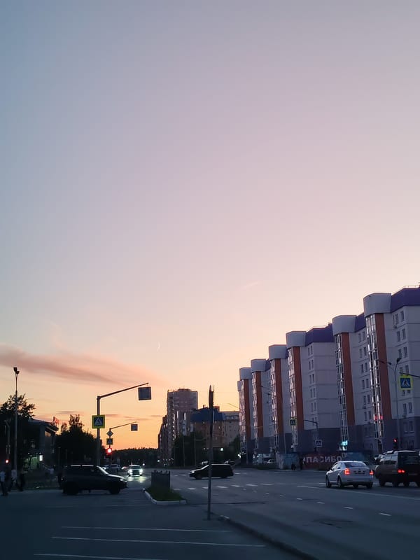 Nizhnevartovsk streets and storefronts at dusk, June evening