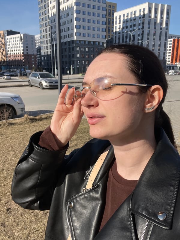 Woman in leather jacket photographed in casual street moments