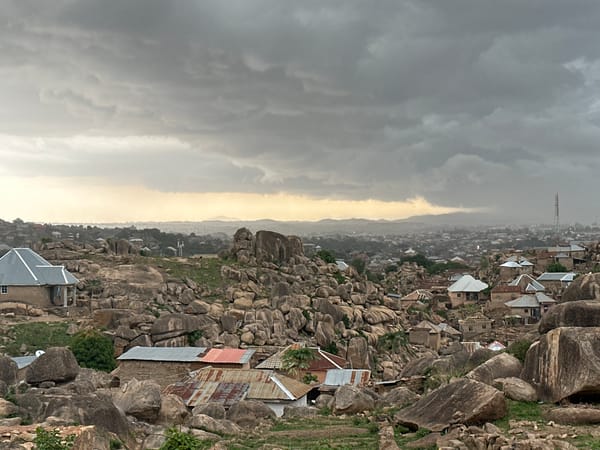 Overcast afternoon captured across Jos Nigeria's boulder-dotted residential landscape