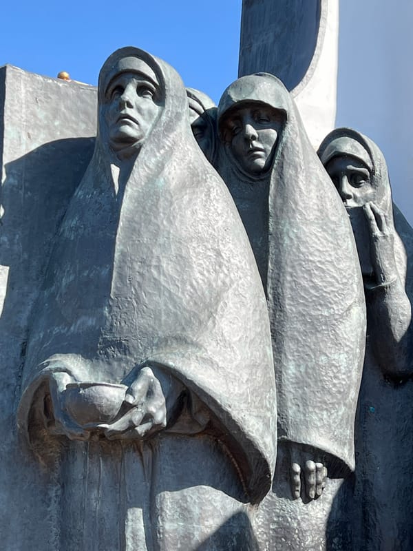 Woman poses on stone ledge in Minsk