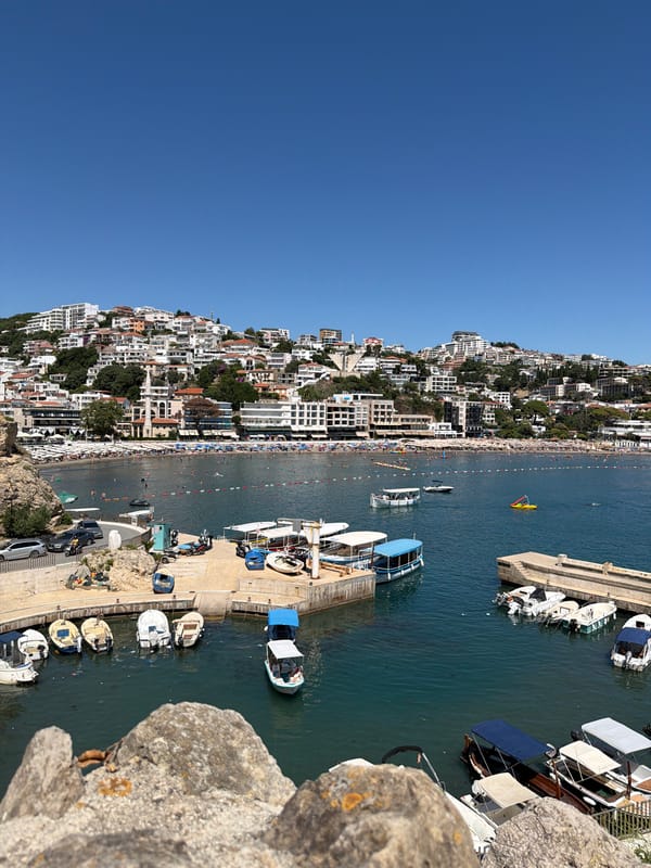 Ulcinj summer: packed beach, jet skis, and napping cats