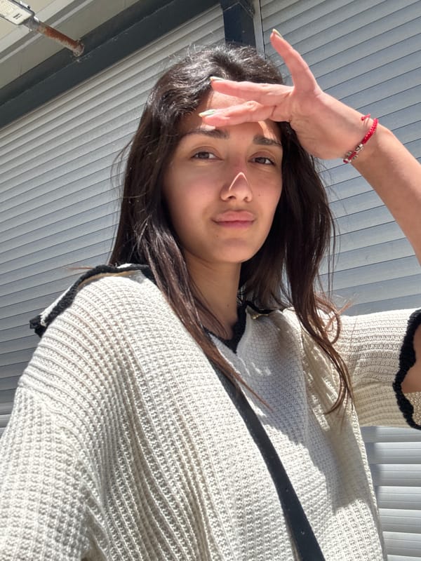 Woman shields eyes from sun on Montenegro street