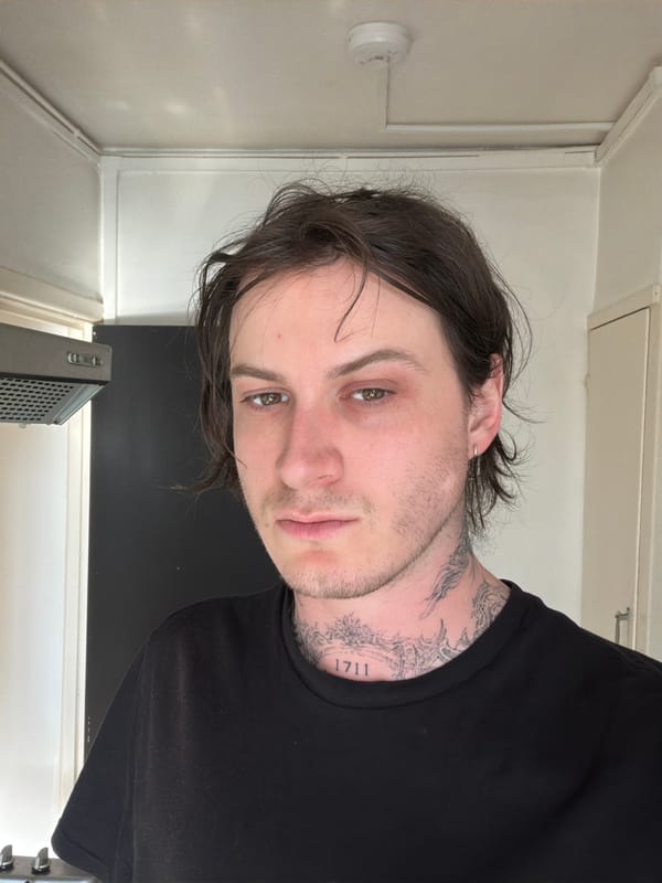 Person with tattoos observed indoors in London room