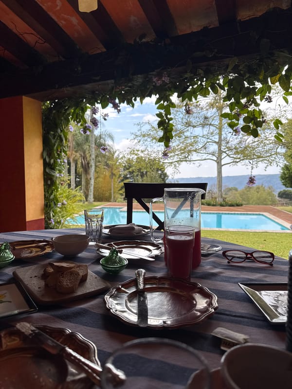 Meal table set with pink drink and bread in Mexico