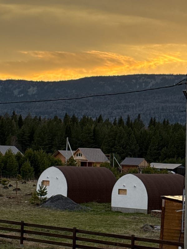 Sunset documentation of rural Tyulyuk landscape with domed structures