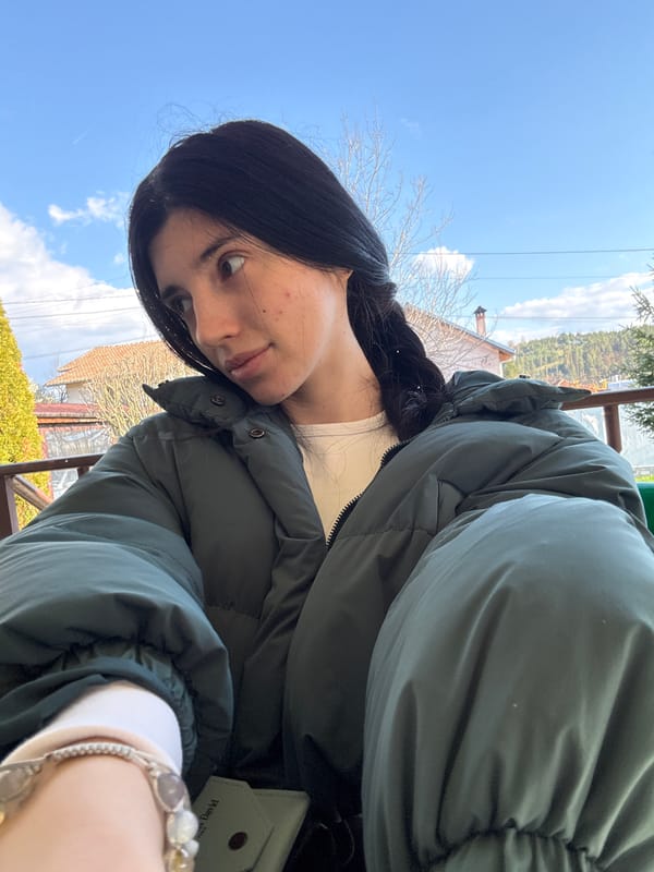 Woman spends afternoon on stone veranda in Chavdar, Bulgaria