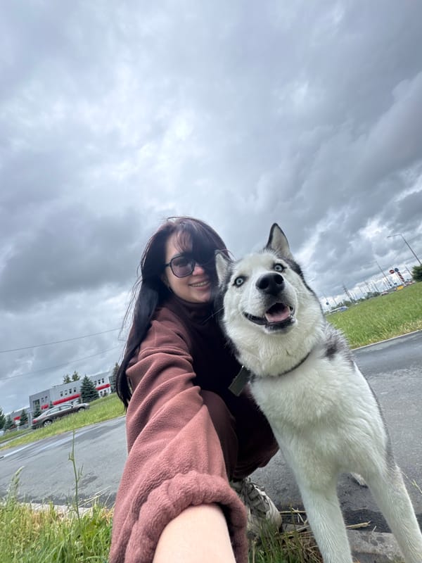 Woman with husky dog, Bengal cat captured in urban setting