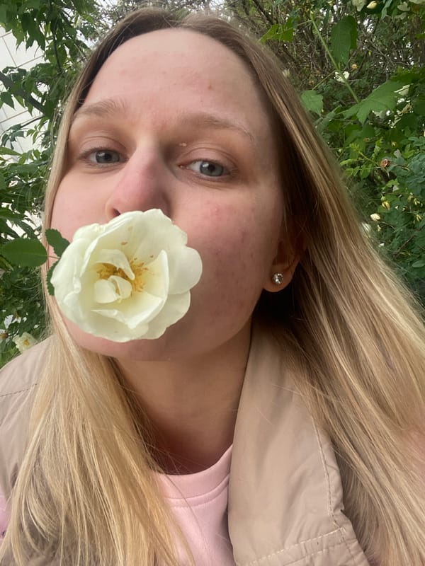 Woman poses among flowers during brief outdoor photo session