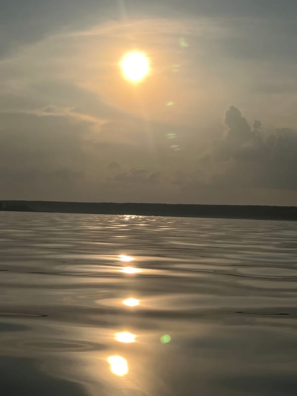 Hazy summer sun over a calm Borovoe lake